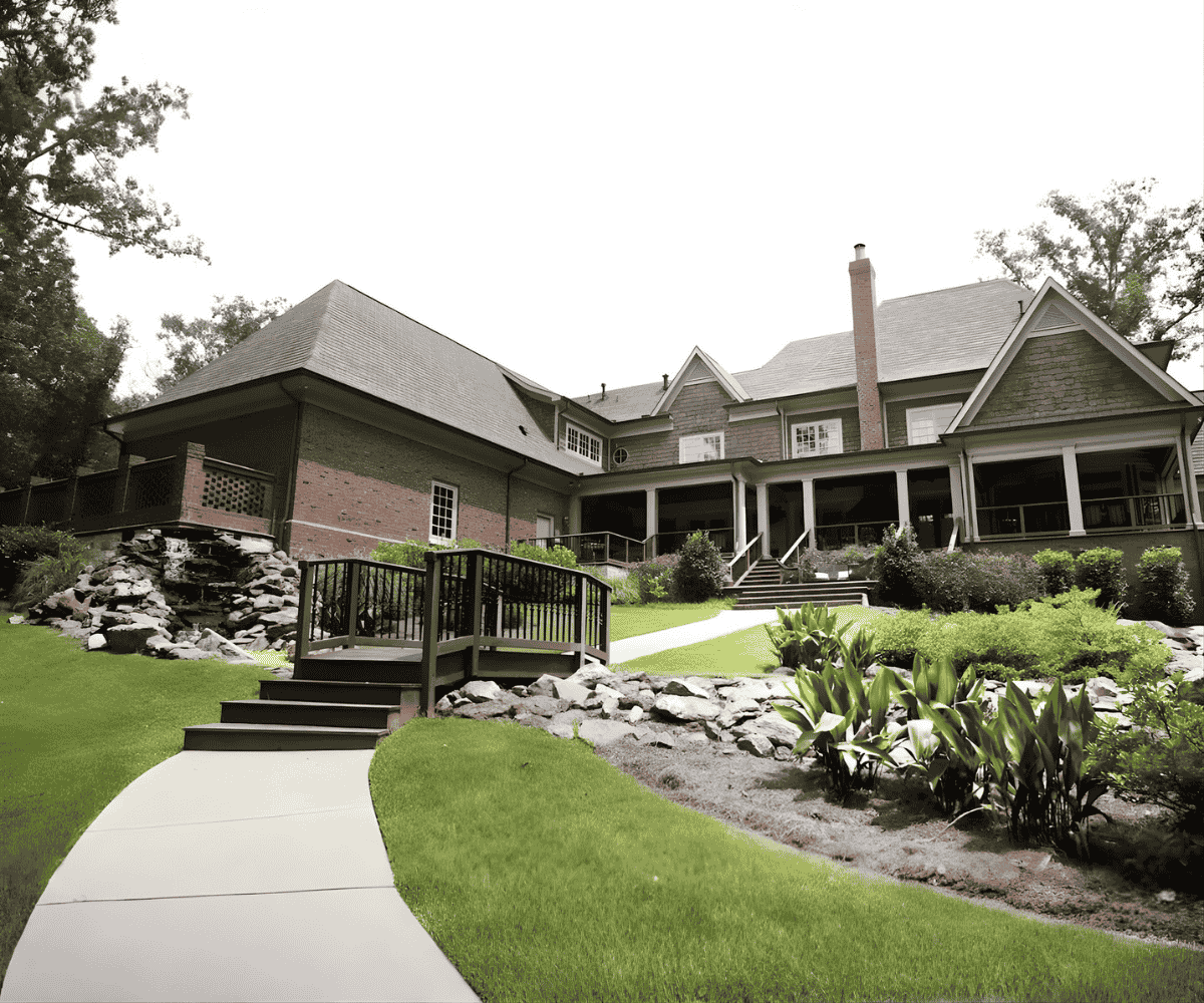 Large residential lawn with striped mowing pattern showing professional lawn maintenance service