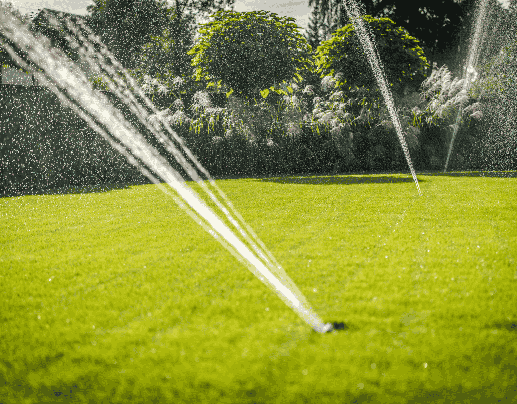 Lawn sprinkler irrigation system watering residential grass landscape in Middle Georgia